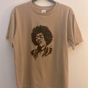 This is a vintage Jimmy Hendrix tee shirt. Tan and black, short sleeve.